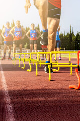 Runners training during the sunny morning on the stadium circuit.