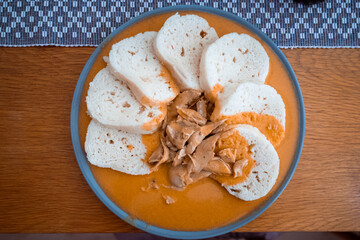 Traditional chicken hen on paprika or paprica creamy sauce with bread dumlings, typical czech food