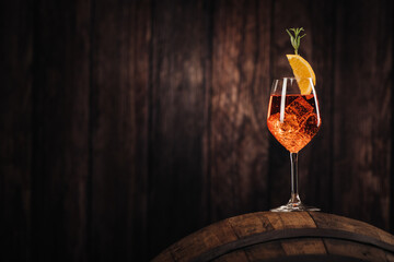 A glass of spritz aperol cocktail decorated with orange on cellar