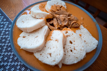 Traditional chicken hen on paprika or paprica creamy sauce with bread dumlings, typical czech food