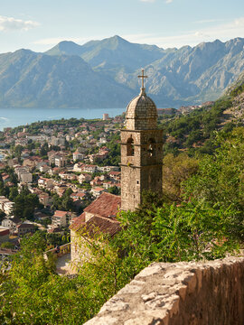 Vertical view of the historic town of Kotor and the Bay of Kotor surrounded by the Balkan Mountains. Sunny day and blue sky in Montenegro on the Adriatic Sea.
