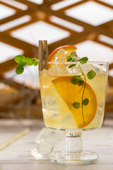 Refreshing homemade lemonade with oranges and mint in glass glasses on the table. Cold summer drink with ice. vertical position.
