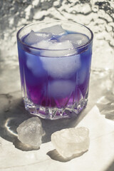 Iced pea flower tea or blue tea. The blue color of the drink will change to purple in an acidic...