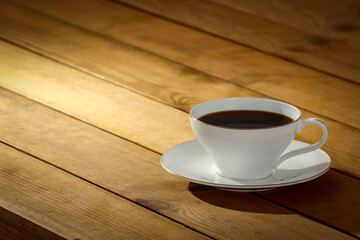 A cup of coffee on the table in the morning of a beautiful holiday day and a free seat