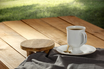 A cup of coffee on the table in the morning of a beautiful holiday day and a free seat