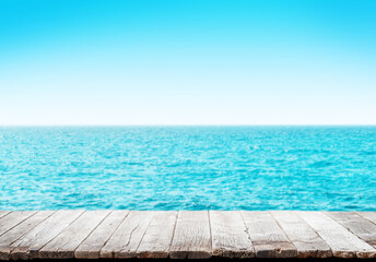 Empty wooden table or pier with sunny sea