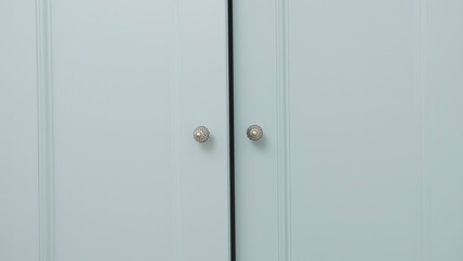 Fototapeta premium Close-up of light cabinet closes. Creative. doors of large wardrobe are closing. Doors of large cabinet slowly close