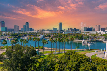 an aerial shot of a gorgeous summer landscape in the harbor with blue ocean water, lush green palm...