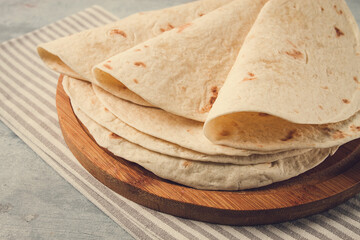 A stack of Mexican tortillas, on a gray table, top view, close-up, no people,