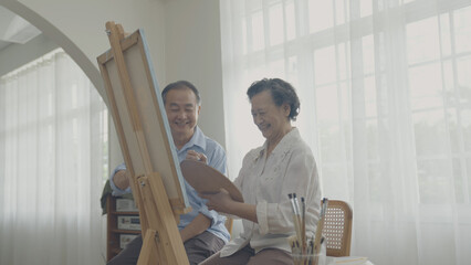 Artist concept of 4k Resolution. Asian families drawing together in the living room. Artist is creating work. Leisure activities and hobbies.