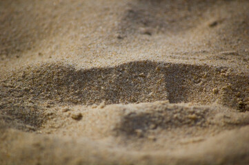 Sand on the beach in a sunny day. Selective focus.