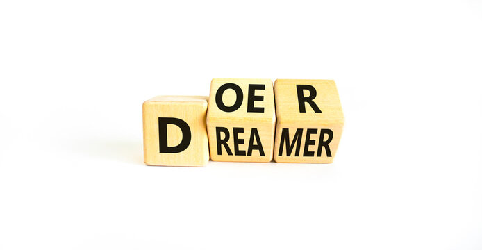 Doer or dreamer symbol. Concept words Doer or dreamer on wooden cubes. Beautiful white table white background. Business and doer or dreamer concept. Copy space.