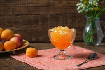 Summer Sicilian dessert granita, frozen fruit juice apricots, peaches, nectarines on a wooden background. Summer cooling, tonic cocktail of crushed ice, a kind of sherbet.