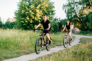 Fototapeta na wymiar Couple riding bicycles rides on paths in the forest