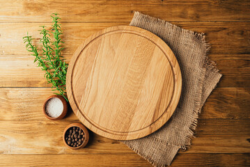 Napkin and pizza board on a wooden table. Stack of colorful dish towels on white wooden table top view mockup. Selective focus.