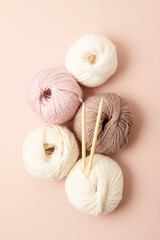 Craft hobby background with yarn in natural colors. Recomforting hobby to reduce stress for cold fall and winter weather. Mock up, copy space, top view