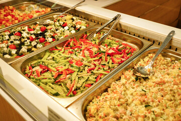 Counter with ready-made salads in the store - 520875028