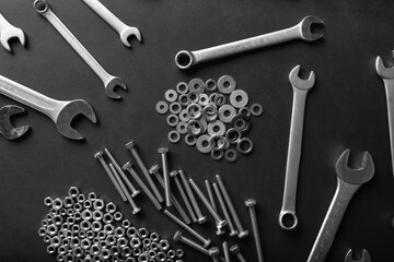 Metal nuts and bolts close up on black background