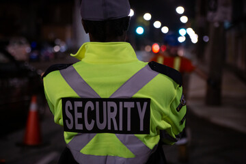 Security guard in car patroling at construction site at night  city