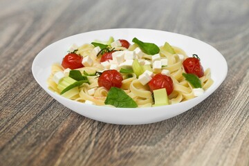 Italian Traditional Dish Pasta a on plate with wooden table background.