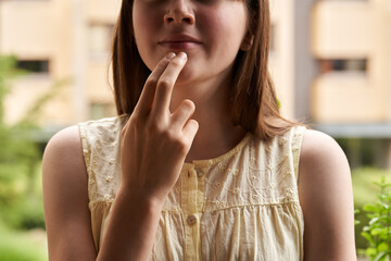 Teenager practicing EFT or emotional freedom technique - tapping on the chin point