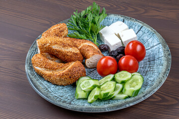 Delicious Traditional Turkish breakfast with Turkish bagel (simit ) include tomatoes, cheese, olives.