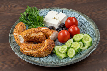 Delicious Traditional Turkish breakfast with Turkish bagel (simit ) include tomatoes, cheese, olives.