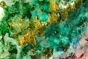Green and blue painting with Alcohol ink fluid abstract texture fluid art with gold glitter and liquid.