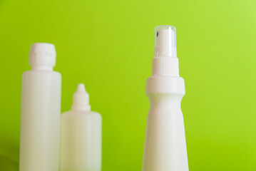 disposable bottles on a table, green background