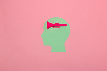 pastel blue head with trumpet brain on pink background, creative art design, love music, love trumpet
