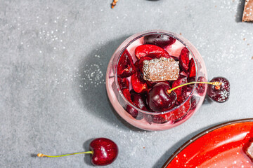 Delicious Italian dessert panna cotta with sweet cherry sauce, fresh berries and chocolate