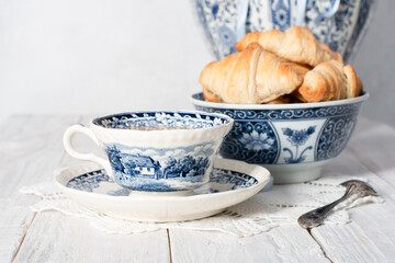 delicate spring still life with croissants and a bouquet of pink peonies 