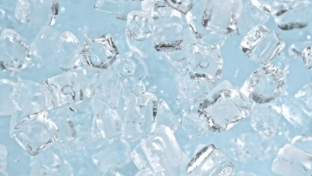 Super Slow Motion Shot of Ice Cubes Explosion Towards Camera on Light Blue Background at 1000 fps.