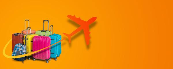 Travel suitcases with the graphics of the departing plane on an orange background