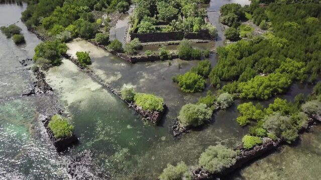 Aerial footage of Nan Madol prehistoric ruined stone city built of basalt slabs. Ancient walls built on artificial islands in the lagoon of Pohnpei, Micronesia, Oceania.