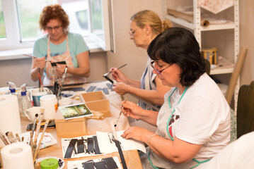 Obraz premium Women in art workshop making decoupage boxes