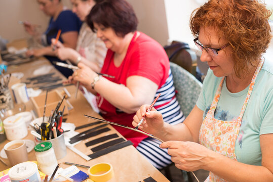 Women in art workshop making decoupage boxes