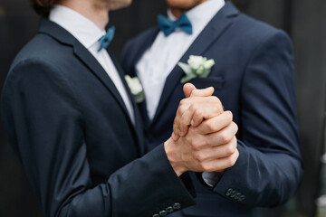 Close up of two men dancing together during wedding ceremony, same sex marriage