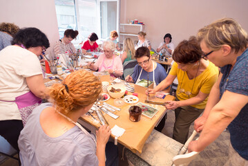 Women in art workshop making decoupage boxes