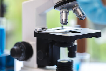 biotechnology scientist using scientific microscope for research in biology medicine laboratory, equipment for chemistry science or microbiology analysis in term of medical technology experiment