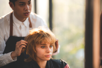 Fototapeta premium concept of professional fashion hairdresser and hair beauty salon, hairstylist making treatment to woman client person, by using scissors for haircut and coiffure care, girl style in studio lifestyle