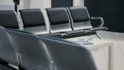 Nobody on empty chairs in waiting room lobby at medical facility, hospital reception with seats in waiting area for checkup visit appointments. Clinic hall for consultation and examination.