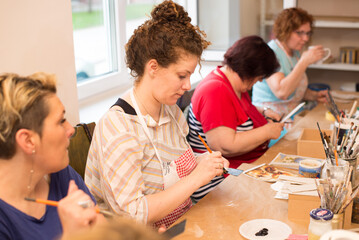 Women in art workshop making decoupage boxes