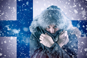 Isolate. Cold weather. Bask. A man in a fur hat and scarf warms his hands with his mouth. It's...