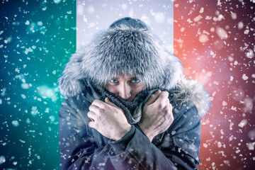 Isolate. Cold weather. Bask. A man in a fur hat and scarf warms his hands with his mouth. It's...