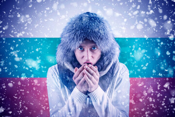 Isolate. Cold weather. Bask. A man in a fur hat and scarf warms his hands with his mouth. It's...