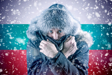 Isolate. Cold weather. Bask. A man in a fur hat and scarf warms his hands with his mouth. It's...