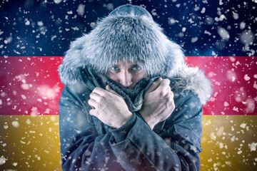 Isolate. Cold weather. Bask. A man in a fur hat and scarf warms his hands with his mouth. It's...