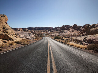 Asphalt road in the mountains. Death Valley. Driving Down Desert road in California.