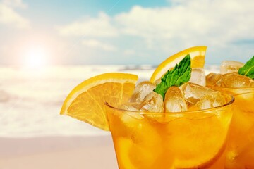 Tasty drinks with blur beach and sunset in background